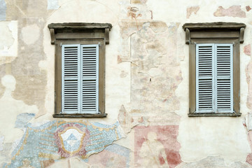 Old faded mural on a wall in Citta Alta Bergamo