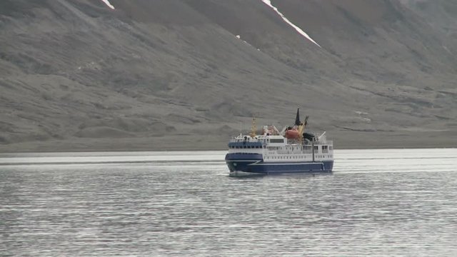 Tourist boat sailing along the coast. Svalbard.