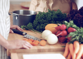 Young woman cutting vegetables in the kitchen