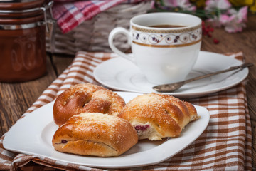 Buns with berries on a wooden table.