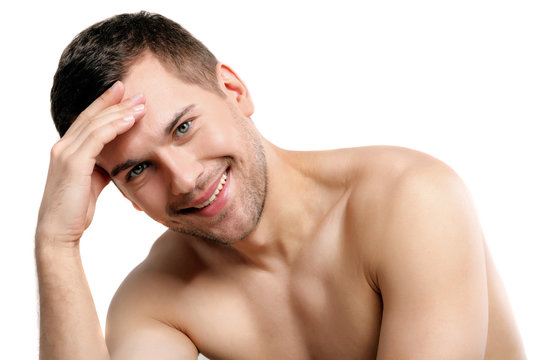 Attractive naked man is evincing his shame