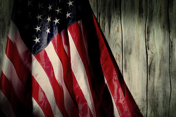 Old flag of United States. Old flag on wooden background. Past times will not return. We've been through a lot.