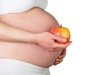 Pregnant woman is holding  apple isolated on white background.