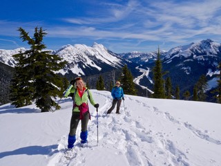 Fototapeta na wymiar Two Women Snowshoeing in Mountains. Yago Peak, Coquihalla Summit Recreation Area near Hope, British Columbia, Canada. 