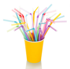 Multi-colored straws for  cocktail in  disposable cup isolated.