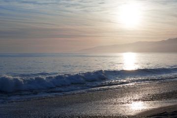 The Pacific ocean during sunset. Landscape with blue sea, the mountains and the dusk sky, the USA, Santa Monica. 