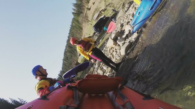 An athlete is preparing to rafting on the river in a kayak. View from the nose canoe.