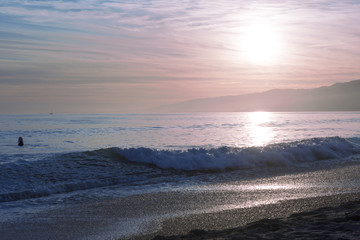 The Pacific ocean during sunset. Landscape with blue sea, the mountains and the dusk sky, the USA, Santa Monica. 