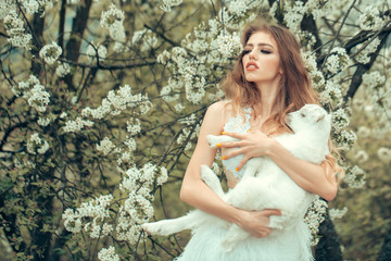 Fototapeta na wymiar Woman with goat in blossom