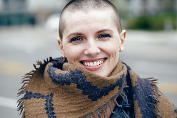 Closeup portrait of happy smiling laughing beautiful Caucasian white young bald girl woman with...