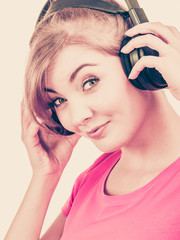 Obraz premium Woman in big headphones listening music