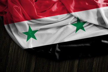 Syrian flag on wooden table