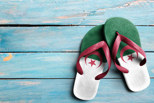 Thongs with flag of Algeria, on blue wooden boards