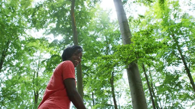  Attractive woman hiking in the woods beckons to camera