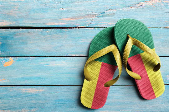 Thongs with flag of Benin, on blue wooden boards