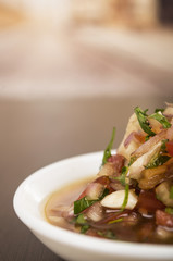 Traditional bowl of ecuadorian encebolladas, very nice presentation, restaurant catering concept, partly visible artistic effect,