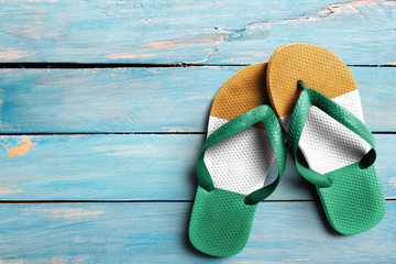 Thongs with flag of Ivory Coast, on blue wooden boards
