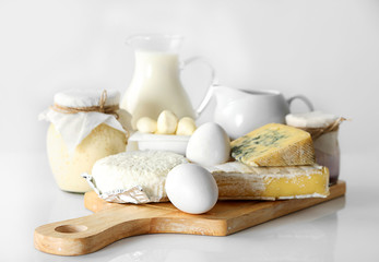 Obraz na płótnie Canvas Set of fresh dairy products on wooden board, isolated on white