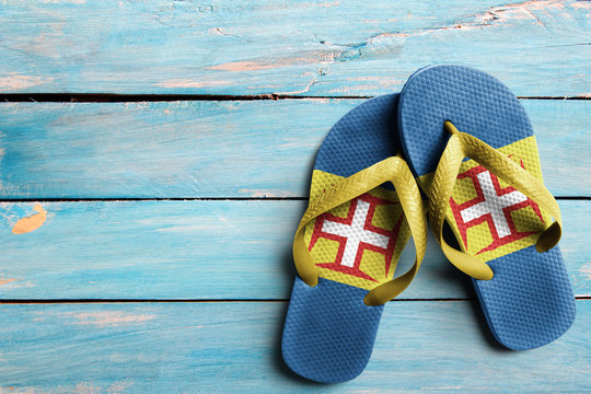 Thongs with flag of Madeira, on blue wooden boards