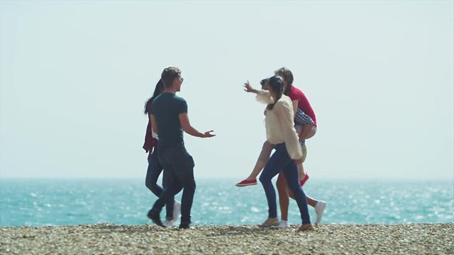 Happy mixed ethnicity group of friends having fun at the beach