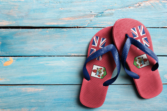 Thongs with flag of Bermuda, on blue wooden boards