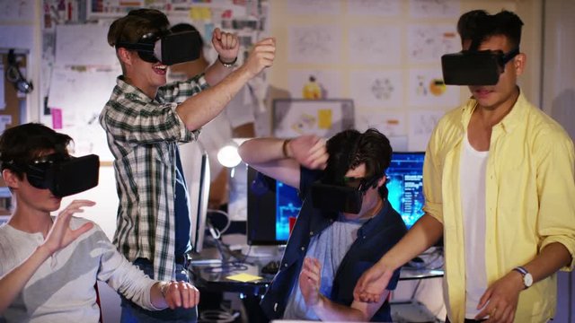  Group of young male computer gamers immersed in a virtual reality game