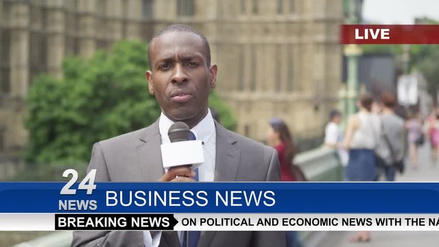  News reporter doing live piece to camera outside London Houses of Parliament.