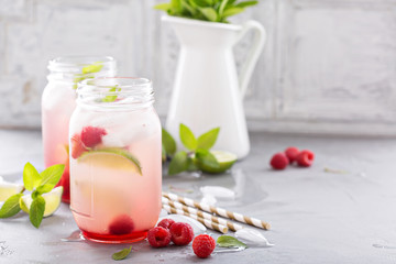 Cold green iced tea with lime and raspberry