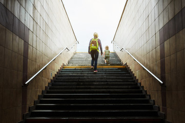 mother and son climbing stairs 