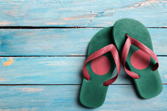 Thongs with flag of Bangladesh, on blue wooden boards