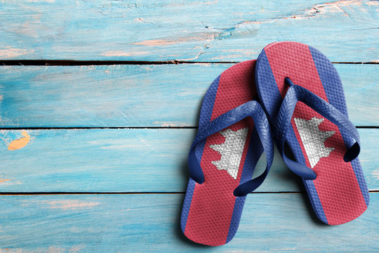 Thongs with flag of Cambodia, on blue wooden boards