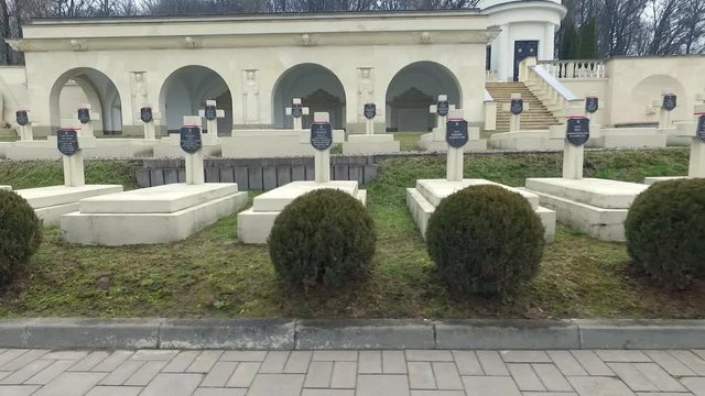 Polish Grave in Lviv. White Crosses and Flowers on the Graves. the Camera Flies Over the Graves of Those Killed in the War Poles. the Crosses Are Decorated With Penta Polish Flag. Grey Sad Weather.