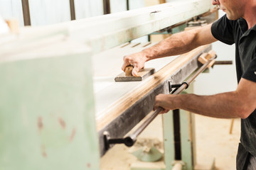 shaving with plane on woodworker workshop