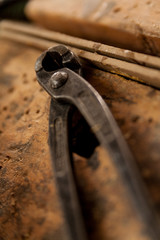 pincers on a retro wooden surface