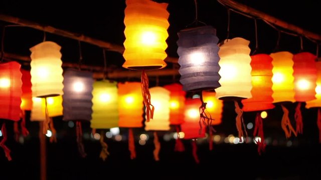 Thai style Lanna flag and Paper lanterns decorated by the river in Yee-peng festival ,ChiangMai Thailand