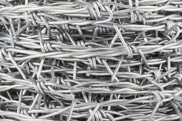 Roll up of barbed wire on white background