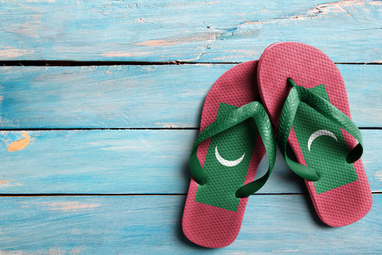 Thongs with flag of Maldives, on blue wooden boards