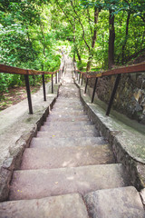 narrow stone staircase in summer park