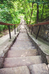 Obraz premium narrow stone staircase in summer park