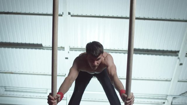  Professional male gymnast training on parallel bars at the gym