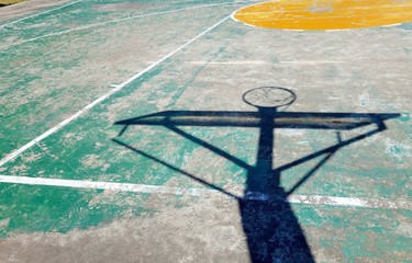 Concrete basketball court with shadow hoop