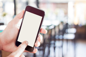 Womanan using smartphone with blurred cafe background