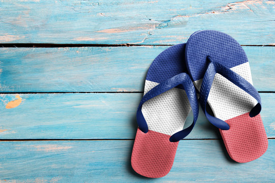Thongs with flag of France, on blue wooden boards