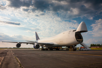 Fototapeta na wymiar Unloading wide-body cargo aircraft