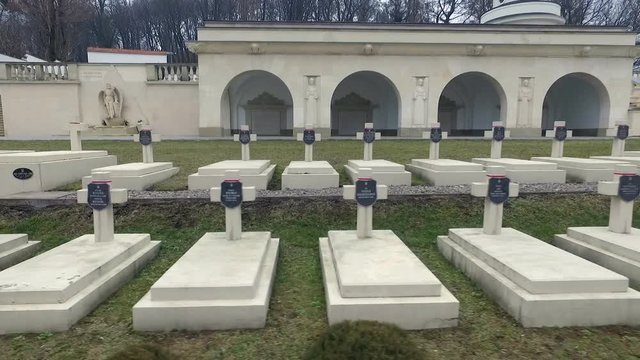Polish Grave in Lviv. White Crosses and Flowers on the Graves. the Camera Flies Over the Graves of Those Killed in the War Poles. the Crosses Are Decorated With Penta Polish Flag. Grey Sad Weather.
