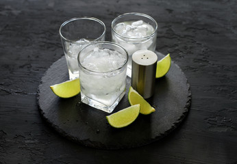 Vodka or gin with ice and lime