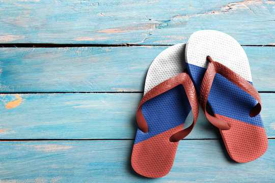 Thongs with flag of Russia, on blue wooden boards