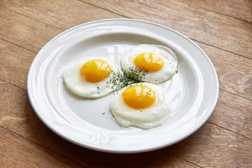 Aluminium Prints Fried eggs Fried eggs in plate on table