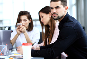Businessman with colleagues in the background