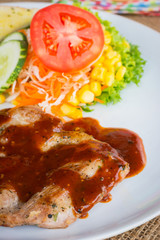 Beef steak with black pepper sauce , salad and French fries on s